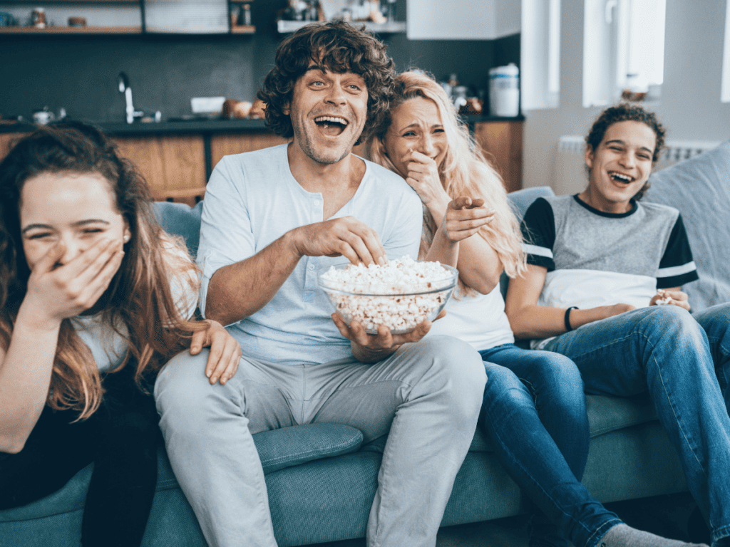family laughing watching movie