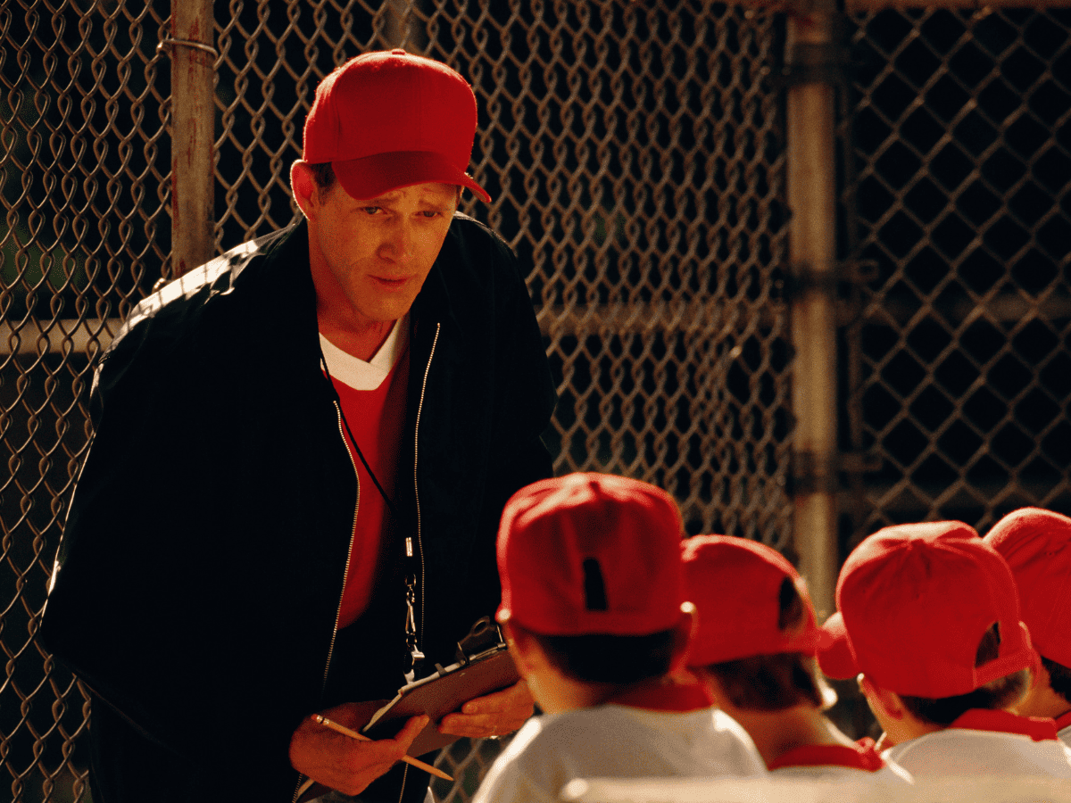 coach talking to baseball players