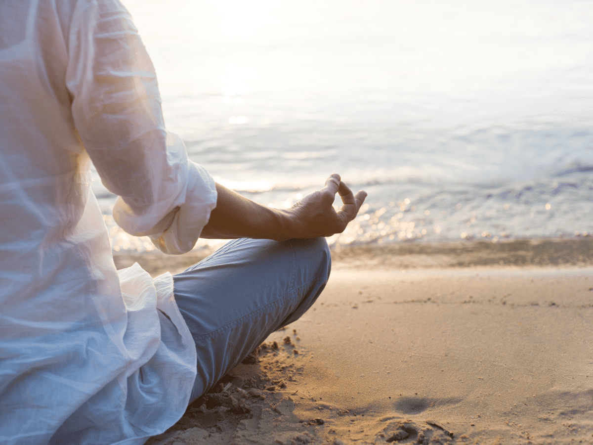 woman meditating by ocean