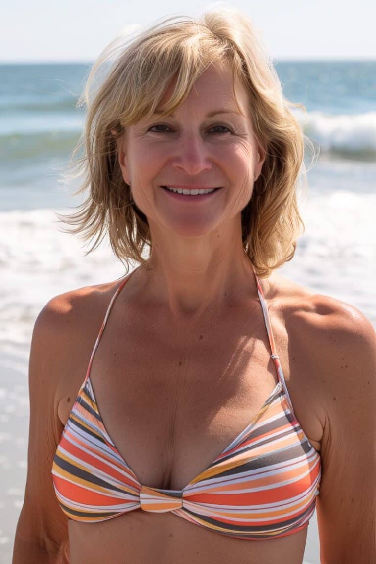Healthy active woman over 40 enjoying sunny day at the beach, smiling, beachwear, fitness, wellness, midlife health, female empowerment, staying fit, outdoor exercise, natural beauty, fitness after 40.